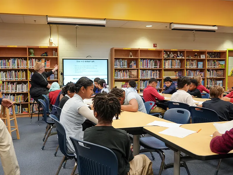 Students and librarian in the Porter Traditional School library
